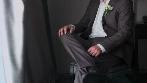 A man in a jacket sits by the window Stock Footage 328370283