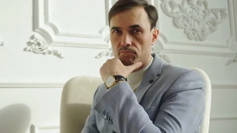 Man in a jacket with a turtleneck strictly looks at the camera. Place to insert Stock Footage 152038801