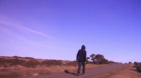 Man in jacket walking country path Stock Footage 47779891