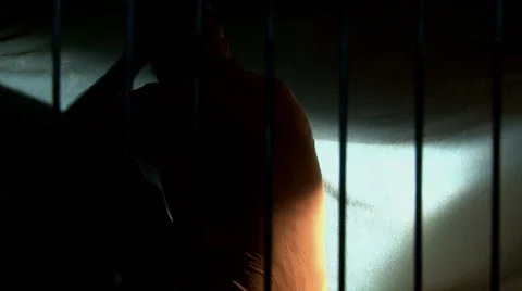Man in jail, prison bars (take 3) - back left Video stock 7758574