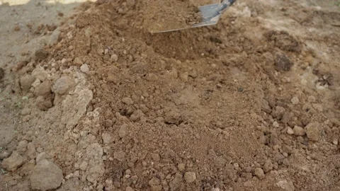 A man in jeans and work gloves digs the ground with a shovel. Stock Footage 155251776