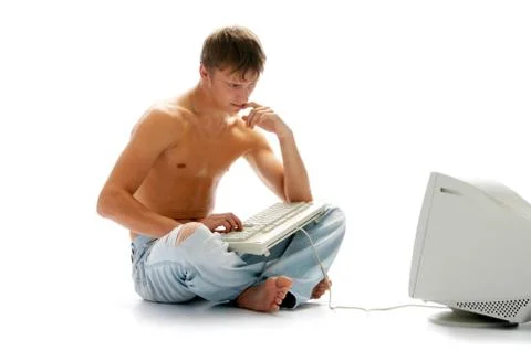 Man in jeans with computer Stock Photos