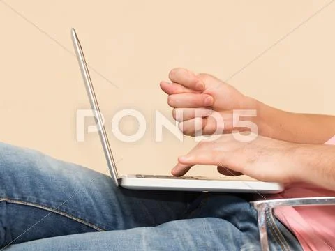 Man In Jeans With A Laptop