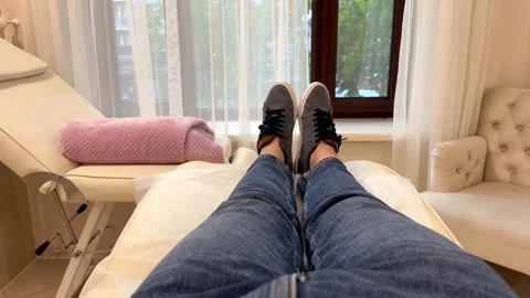 A man in jeans is lying on a sofa Stock Footage 244814275