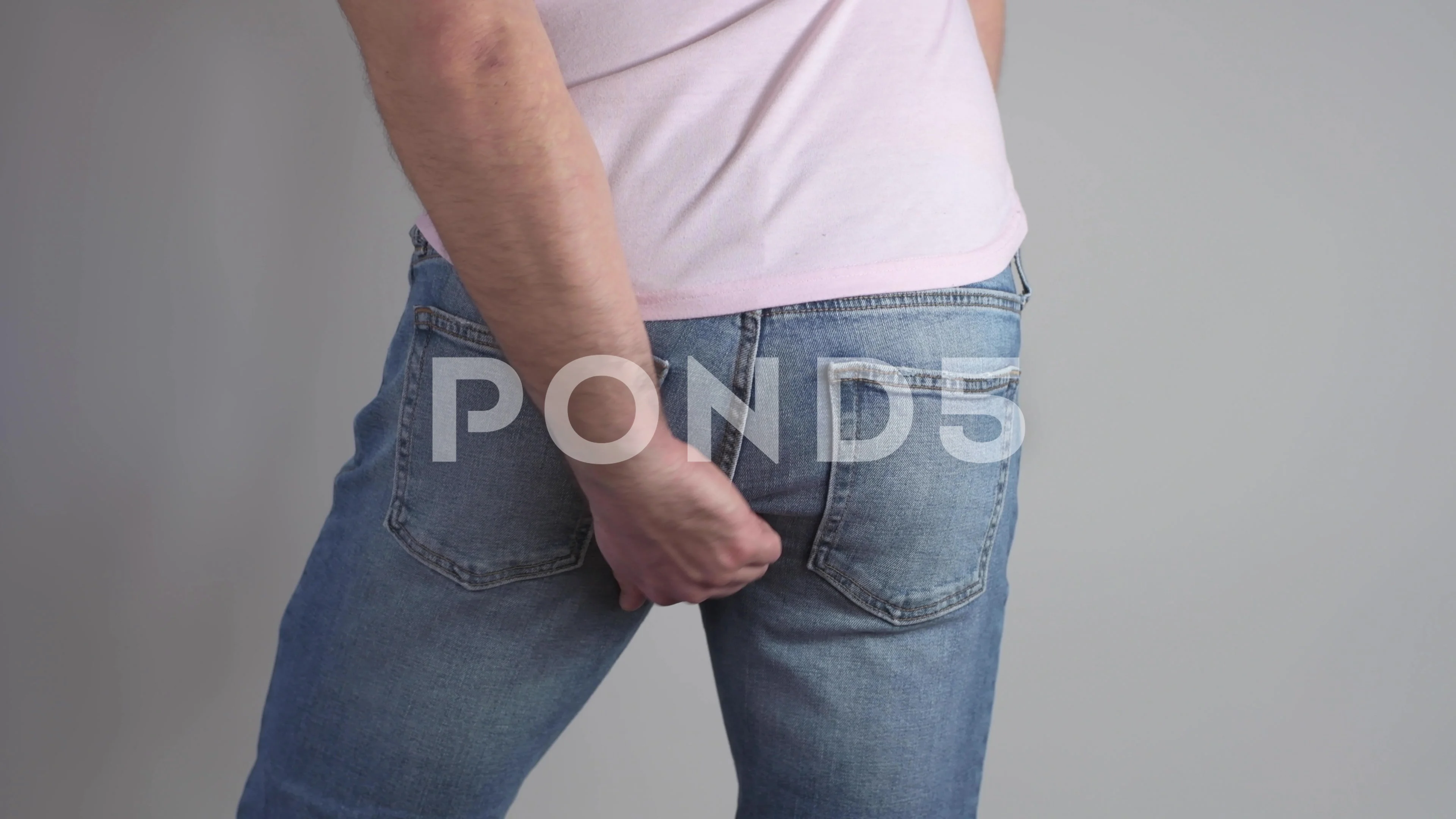 Black homeless man scratching his ass