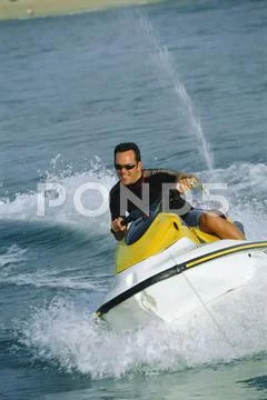 Man jet skiing and smiling (selective focus) Stock Photos