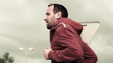 Man jogging against cloudy sky, super slow motion, shot at 240fps HD Stock Footage 40103958