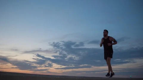 Man jogging alone on shore. Stock Footage 102031531