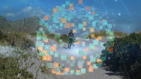 Man jogging along sandy dune path, displaying floating tech icons and graphs for Stock Footage 308026107