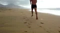 Man jogging on the beach - back view HD Footage