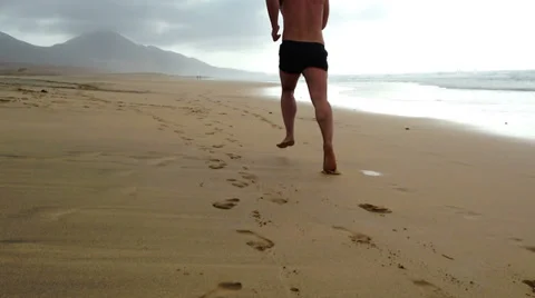 Man jogging on the beach - back view Stock Footage 37733452