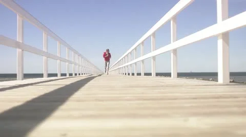 A man jogging on the beach Stock Footage 11287053