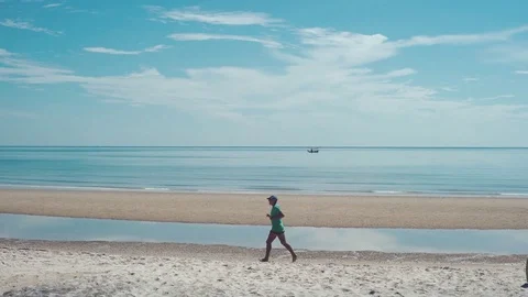 A Man Jogging On the Beach. Stock Footage 79682614