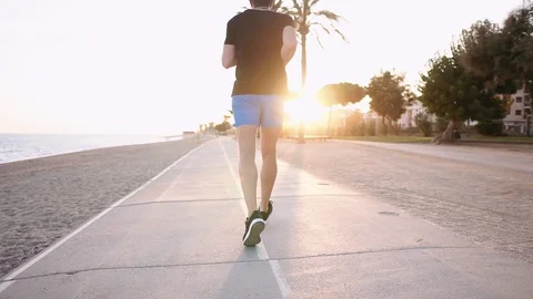 Man jogging on a beach. Stock Footage 104864433