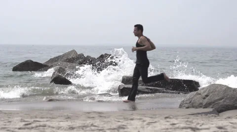 Man jogging at the beach. slow motion. jogger Stock-Footage 32020110