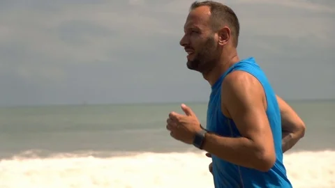 Man jogging on beautiful beach, super slow motion Stock Footage 71365113