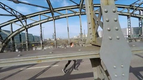 Man jogging on bridge Stock Footage