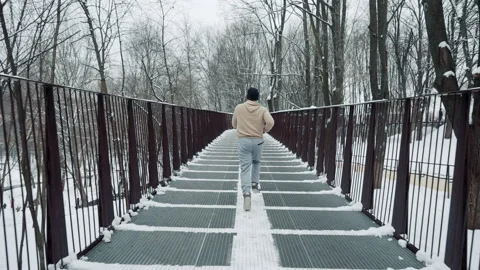 Man jogging on bridge in winter Stock Footage 147049555