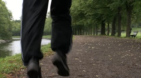 Man jogging by a canal Stock Footage 11290285