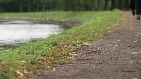 Man jogging by a canal Stock Footage 11290286