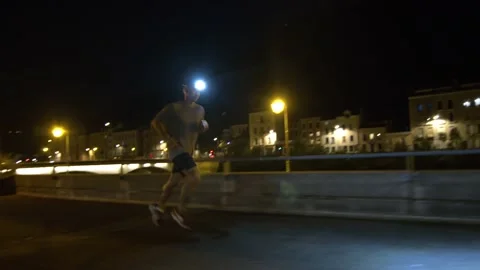 A man jogging in the city at night with his headlamp Stock Footage 211778149