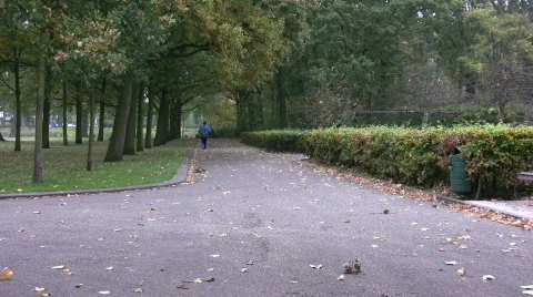 Man jogging in the distance Stock Footage 108243