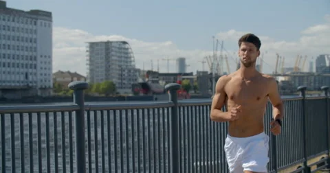 Man Jogging in Docklands on Sunny Day. 스톡 동영상 68043530