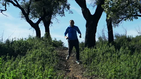 Man jogging downhill in park, super slow motion Vídeo Stock 60123376