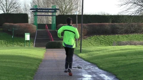 Man jogging on a footpath in a park Stock Footage 46554251