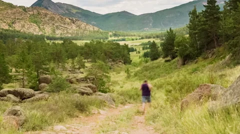 Man Jogging on the Mountain Valley Video stock 48847896