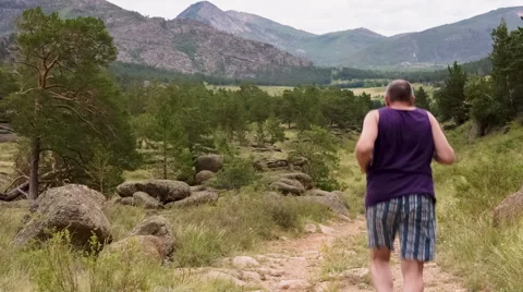 Man Jogging on the Mountain Valley Stock Footage 48856617