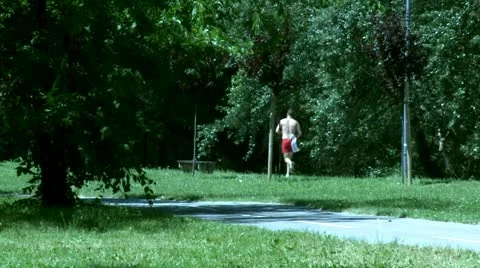 Man jogging in park Stock Footage 11218129