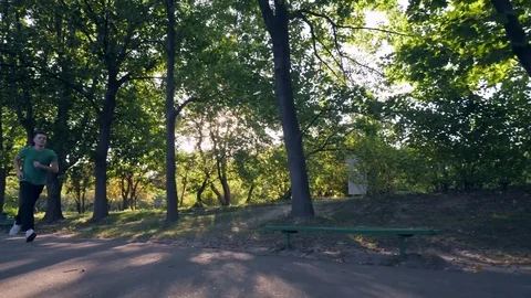 Man jogging in park Stock Footage 82062946