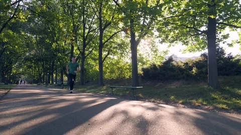 Man jogging in park Stock Footage 82062953