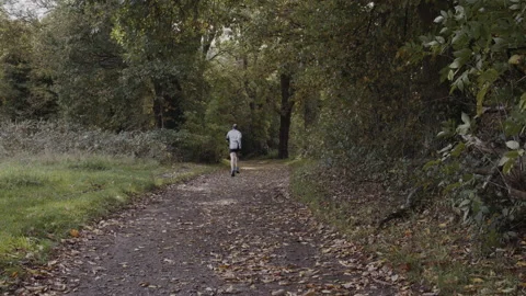 Man jogging in a path in park/forest 動画素材 142277615