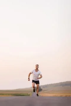 Man jogging on road Stock Photos