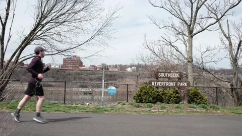 Man jogging Southside River front park Stock Footage 176326963