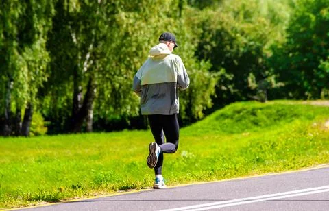 A man Jogging in a summer Park 写真素材
