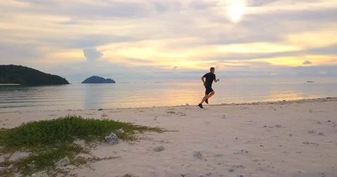 Man jogging at sunset beach Stock Footage 89250870