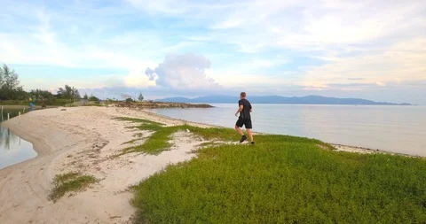 Man jogging at sunset beach Stock Footage 89254635