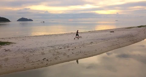 Man jogging at sunset beach Stock Footage 89284414