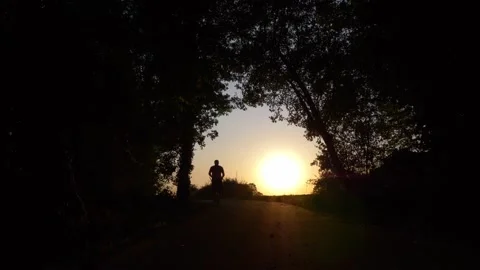 Man jogging at sunset in silhouette Video stock 284108840