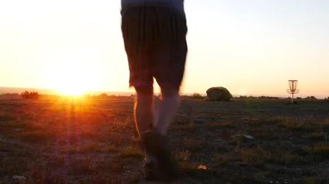 Man jogging towards the sunset. Stock Footage 54514010