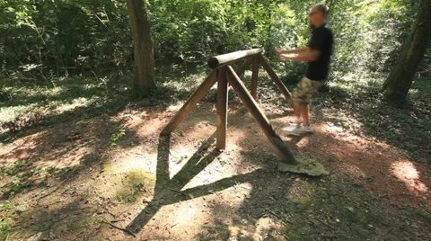Man Jogging at trim lane - jumping over tree trunk Stock Footage 35894537