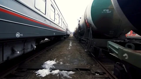 The man jogs against the background of two trains Video stock 84115446