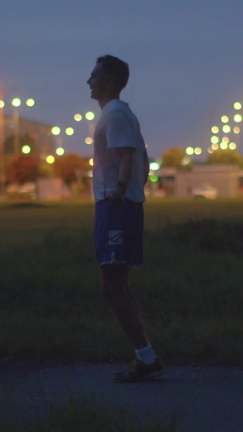 A man jogs, jumps rope, and reflects on his workout at night Stock Footage 317340747
