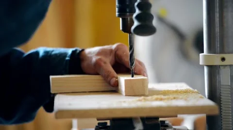 The man on the joiner's machine saws a wooden board Stock Footage 56231951