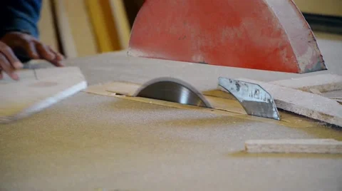 The man on the joiner's machine saws a wooden board Stock Footage 56232717
