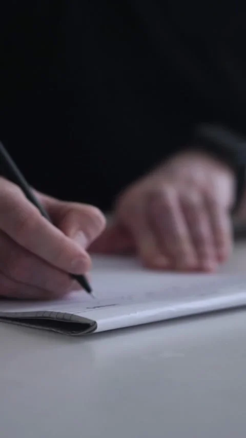 Man journaling thoughts into notebook Видео 304083505