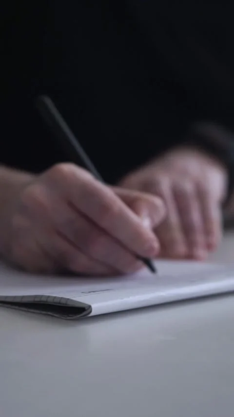 Man journaling thoughts into notebook Stock Footage 304083513